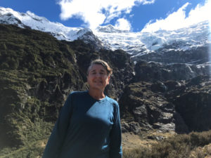 Mary at the top of the Rob Roy Glacier walk, with a hanging glacier behind her