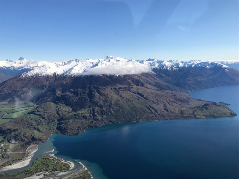 view from airplane over Lake Wanaka and Southern Alps on the way to Milford Sound